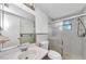 Bright bathroom featuring updated vanity and tiled shower at 4143 Gray Squirrel Ln, New Port Richey, FL 34653