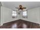 Bright bedroom with hardwood floors, ceiling fan, and lots of natural light at 4143 Gray Squirrel Ln, New Port Richey, FL 34653