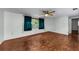 Spacious bedroom with hardwood floors, large window, and ceiling fan at 4143 Gray Squirrel Ln, New Port Richey, FL 34653