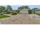 This home has a long driveway and a garage; surrounded by mature landscaping at 4143 Gray Squirrel Ln, New Port Richey, FL 34653