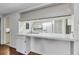 Kitchen featuring an eat-in bar area with white cabinetry and modern stainless steel sink fixtures at 4143 Gray Squirrel Ln, New Port Richey, FL 34653