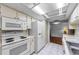 Efficient kitchen with white cabinets, updated appliances, and tiled flooring at 4143 Gray Squirrel Ln, New Port Richey, FL 34653