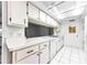 Functional kitchen with white cabinets, countertop, and tiled floor at 4143 Gray Squirrel Ln, New Port Richey, FL 34653
