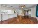 Bright living room with hardwood floors and open kitchen at 4143 Gray Squirrel Ln, New Port Richey, FL 34653