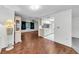 Combined living spaces featuring hardwood flooring, neutral carpet, and an open kitchen view at 4143 Gray Squirrel Ln, New Port Richey, FL 34653