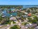 An aerial view shows waterfront homes with docks and boat access in a lush, green neighborhood at 4146 Harbor Hills Dr, Largo, FL 33770