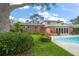 Well-maintained backyard featuring a private pool, manicured lawn, and a charming fountain at 4146 Harbor Hills Dr, Largo, FL 33770