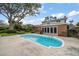 A private backyard with a large pool and lush greenery provides a serene outdoor retreat at 4146 Harbor Hills Dr, Largo, FL 33770