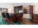 Elegant bar area with dark wood cabinetry, black countertop, seating, and views to the dining room at 4146 Harbor Hills Dr, Largo, FL 33770