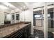 This newly renovated bathroom features marble floors, granite countertops, and plenty of cabinet space at 4146 Harbor Hills Dr, Largo, FL 33770