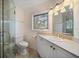 Bright bathroom with modern fixtures, including a glass shower, marble countertop, and vanity at 4146 Harbor Hills Dr, Largo, FL 33770