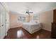 Bright bedroom featuring hardwood floors, a ceiling fan, and a large window for natural light at 4146 Harbor Hills Dr, Largo, FL 33770
