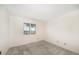 This bedroom has neutral carpeting, white walls, and a bright window overlooking the water at 4146 Harbor Hills Dr, Largo, FL 33770