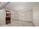 Bright dining room featuring a modern chandelier, neutral walls, and mirrored wall that opens up to another living space at 4146 Harbor Hills Dr, Largo, FL 33770
