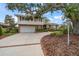 Charming two-story home with well-manicured landscaping and a spacious driveway with brick trim at 4146 Harbor Hills Dr, Largo, FL 33770