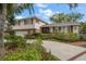 Charming two-story home with a manicured front yard, brick accents, and lush landscaping at 4146 Harbor Hills Dr, Largo, FL 33770