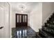 A grand foyer features a stunning chandelier, marble floors, and elegant double doors at 4146 Harbor Hills Dr, Largo, FL 33770