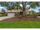 Front yard of home featuring an abundance of trees and landscaping for added privacy at 4146 Harbor Hills Dr, Largo, FL 33770