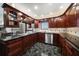 Gourmet kitchen with custom wood cabinetry, granite countertops, and stainless steel appliances at 4146 Harbor Hills Dr, Largo, FL 33770