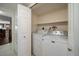 Convenient laundry area with white appliances and built-in shelving at 4146 Harbor Hills Dr, Largo, FL 33770