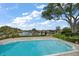 A large, serene pool offers stunning waterfront views and is surrounded by lush landscaping at 4146 Harbor Hills Dr, Largo, FL 33770