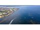 Beautiful aerial view of the neighborhood with a vast ocean and several boats sailing on the water at 4252 Floramar Ter, New Port Richey, FL 34652