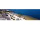Scenic aerial view of a white sand beach with palm trees and blue water at 4252 Floramar Ter, New Port Richey, FL 34652