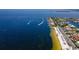 Beautiful waterfront property with many houses, boats, and a sandy beach on the coast of the ocean at 4252 Floramar Ter, New Port Richey, FL 34652