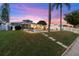 A beautifully landscaped waterfront backyard with green lawn, private patio, and canal access perfect for relaxing or entertaining at 4252 Floramar Ter, New Port Richey, FL 34652