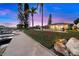 Beautiful waterfront backyard view featuring a private dock with canal access, a house, a green lawn, and palm trees at 4252 Floramar Ter, New Port Richey, FL 34652
