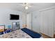 Comfortable bedroom with ceiling fan, closet space and a view of the hallway at 4252 Floramar Ter, New Port Richey, FL 34652