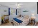Cozy bedroom featuring light blue walls, a ceiling fan, and natural light at 4252 Floramar Ter, New Port Richey, FL 34652
