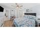 Well-lit bedroom featuring wood-look flooring, ceiling fan and a large comfortable bed at 4252 Floramar Ter, New Port Richey, FL 34652
