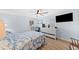Bright bedroom featuring light blue walls, wood flooring, a ceiling fan, and a white dresser at 4252 Floramar Ter, New Port Richey, FL 34652