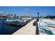 Waterfront view of boat dock featuring several boats with an adjacent patio and waterfront lounge chairs at 4252 Floramar Ter, New Port Richey, FL 34652