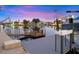 Waterfront home featuring a private dock with boat lift on a calm canal and with lovely reflection on the water at 4252 Floramar Ter, New Port Richey, FL 34652
