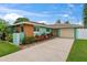 Charming one-story home with a large driveway, stone accents, and manicured landscaping at 4252 Floramar Ter, New Port Richey, FL 34652