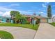 Charming single-story home featuring a large driveway, lawn, and vibrant landscaping at 4252 Floramar Ter, New Port Richey, FL 34652