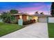 Charming one-story home featuring a large driveway, manicured lawn, and well-maintained landscaping at 4252 Floramar Ter, New Port Richey, FL 34652