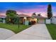 Charming one-story home with a well-manicured lawn, stone accents, and large driveway at 4252 Floramar Ter, New Port Richey, FL 34652