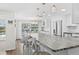 Bright kitchen with a large island, seating for four, and views of the pool and backyard through sliding doors at 4252 Floramar Ter, New Port Richey, FL 34652
