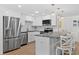 Modern kitchen featuring stainless steel appliances, granite countertops, and breakfast bar at 4252 Floramar Ter, New Port Richey, FL 34652