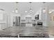 Modern kitchen with stone countertops, stainless steel appliances, and custom cabinetry at 4252 Floramar Ter, New Port Richey, FL 34652