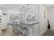 Modern kitchen featuring stainless steel appliances, white cabinetry, and a large granite countertop island at 4252 Floramar Ter, New Port Richey, FL 34652