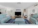 Comfortable living room with a large television, cozy furniture, and stylish coastal-themed decor at 4252 Floramar Ter, New Port Richey, FL 34652