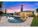 Pool area with sun loungers overlooking a lush backyard and outdoor living spaces at 4252 Floramar Ter, New Port Richey, FL 34652