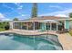 Stunning backyard pool area with a canal view and a screened-in lanai perfect for outdoor living and entertaining at 4252 Floramar Ter, New Port Richey, FL 34652