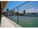 Image displays outdoor tennis courts with new black fencing and palm trees nearby at 4252 Floramar Ter, New Port Richey, FL 34652