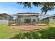 Wide view of backyard with pool and home at 4634 Mapletree Loop, Wesley Chapel, FL 33544