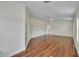 Spacious bedroom featuring gleaming hardwood floors, large windows, and neutral wall colors at 4634 Mapletree Loop, Wesley Chapel, FL 33544